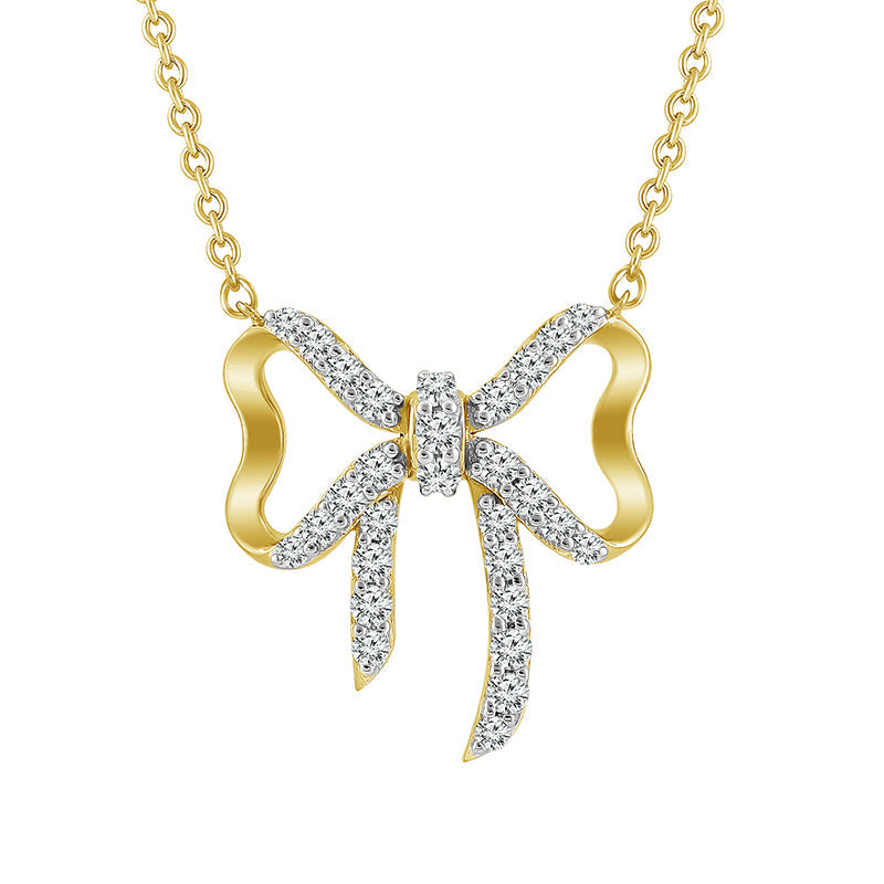 A 10K yellow gold diamond pendant in the shape of a bow with a chain.